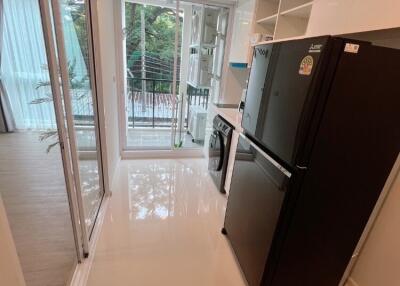 Modern kitchen with black appliances and large window