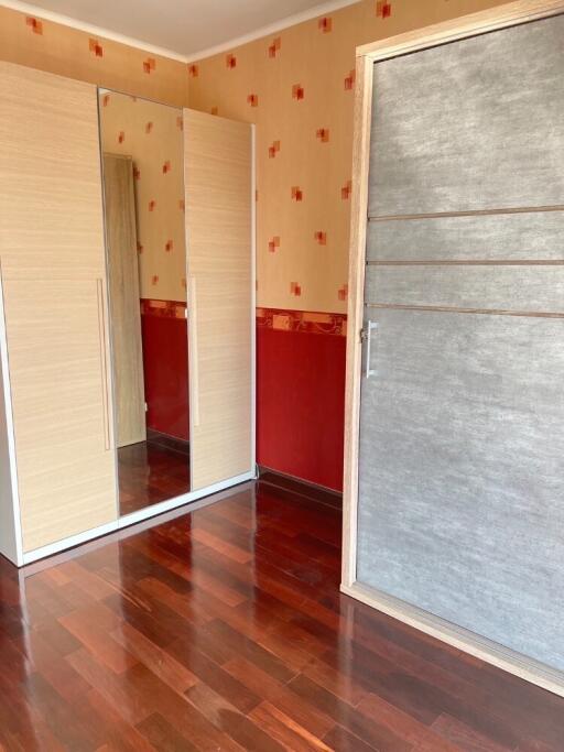 Bedroom with wardrobes and wooden flooring