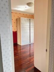 Bedroom with wooden wardrobe and hardwood floor