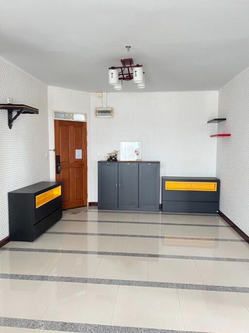 Empty living room with wooden door and cabinets