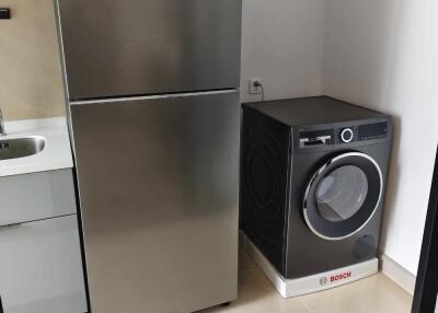 Laundry area featuring a refrigerator and washing machine