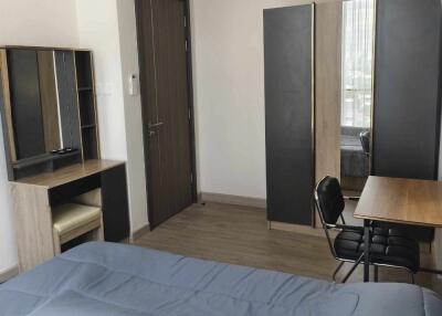 Modern furnished bedroom with desk and wardrobe