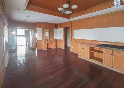 Spacious living room with wooden flooring and built-in cabinetry