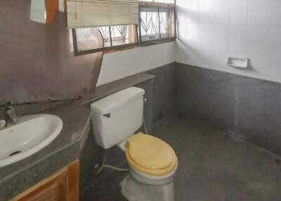 Bathroom with sink, toilet, and window