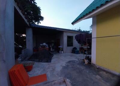 Outdoor area of a property with visible structures and materials.