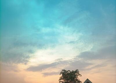 Small house during sunset with a clear, calm sky