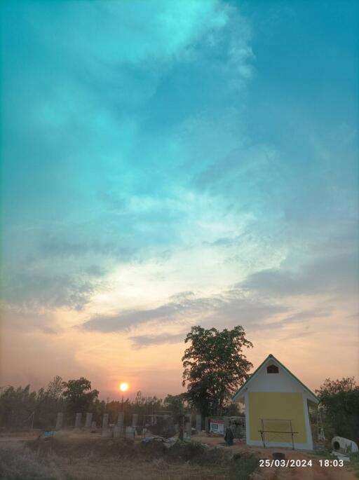 Small house during sunset with a clear, calm sky