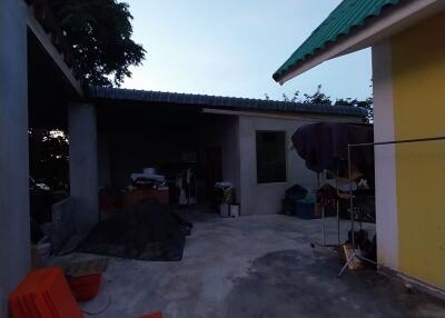 Outdoor area with various items and shadow near a building