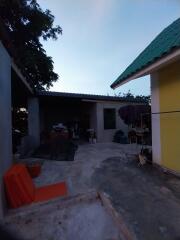 Outdoor area with various items and shadow near a building