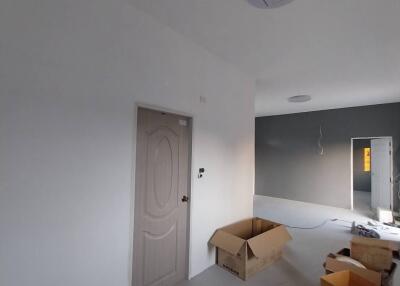 Unfurnished bedroom with a door and ceiling lights