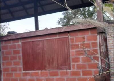 Outdoor structure with brick walls and wooden roof