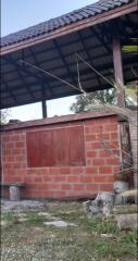 Outdoor structure with brick walls and wooden roof