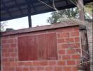 Outdoor structure with brick walls and wooden roof