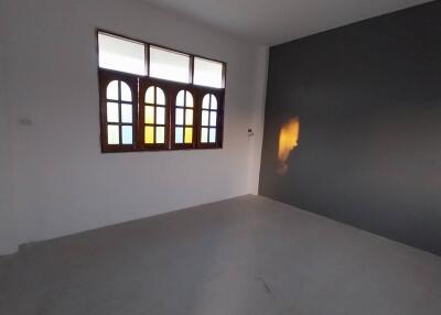 Empty bedroom with colorful window panes