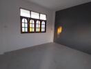 Empty bedroom with colorful window panes