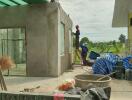 Building under construction with two workers outside