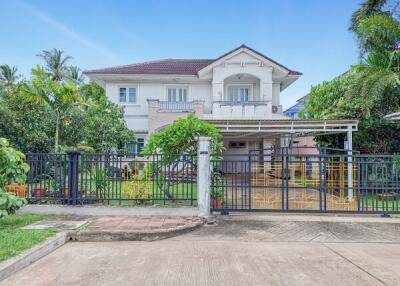 Modern two-story house exterior with a front yard