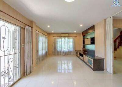 Spacious living room with built-in shelving and large windows