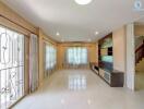 Spacious living room with built-in shelving and large windows