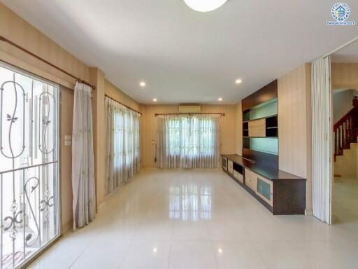 Spacious living room with built-in shelving and large windows