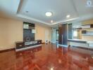 Spacious living room with wooden flooring and modern built-in storage units