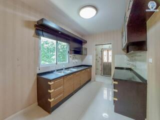 Modern kitchen with wooden cabinets and large window