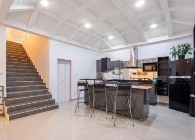 Modern kitchen with island and bar stools in a spacious open-plan design