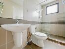 Modern bathroom with sink, toilet, and walk-in shower