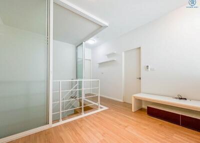 Modern living room with wooden floor and white walls