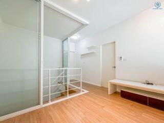 Modern living room with wooden floor and white walls