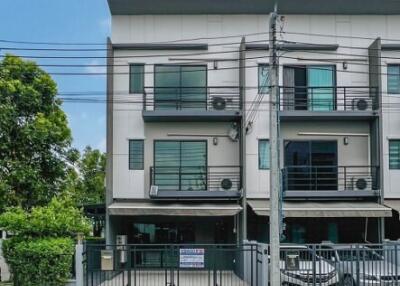 Front view of a modern three-story townhouse