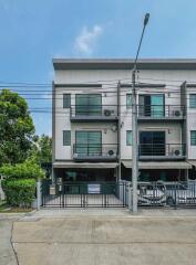 Front view of a modern three-story townhouse