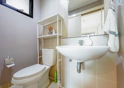 Modern bathroom with white fixtures and shelving