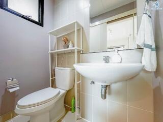 Modern bathroom with white fixtures and shelving