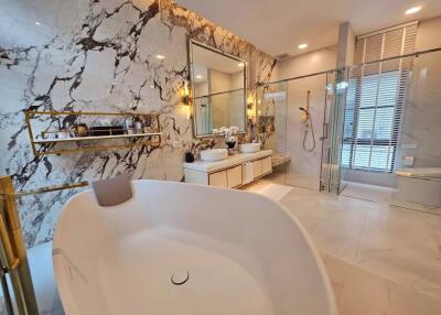 Luxurious bathroom with marble walls and modern amenities