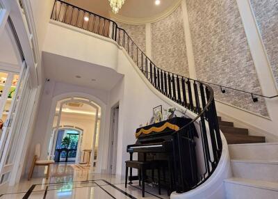 Elegant foyer with grand staircase and chandelier