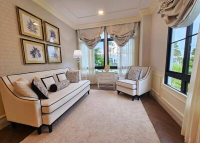 Elegant living room with white sofa and armchairs