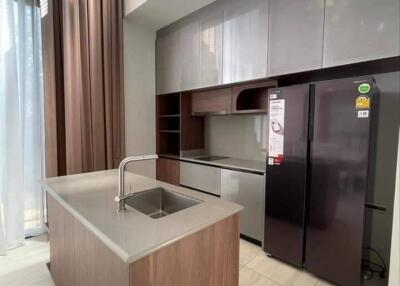 Modern kitchen with island, cabinets, and refrigerator