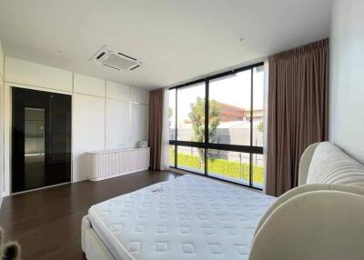 Spacious bedroom with large window and air conditioning