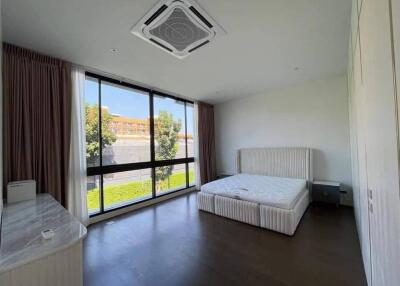 Spacious bedroom with large window and natural light