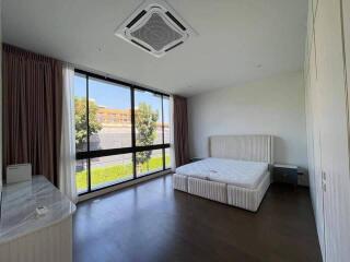 Spacious bedroom with large window and natural light