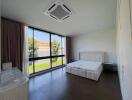 Spacious bedroom with large window and natural light