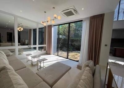 Spacious living room with modern lighting and large glass doors