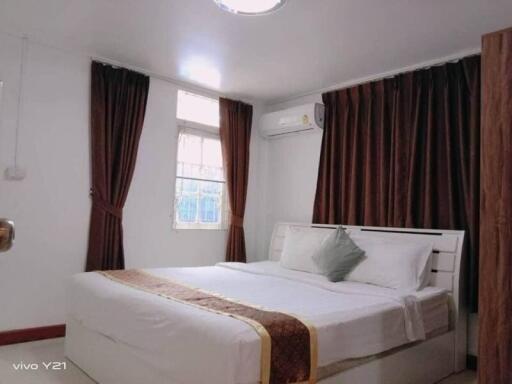 Spacious and well-decorated bedroom with double bed and curtains