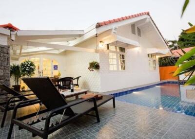 Outdoor lounging area with pool