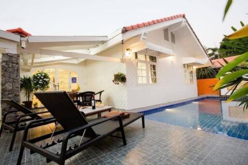 Outdoor lounging area with pool