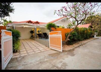 Front view of a house with a driveway and garden