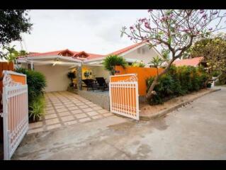 Front view of a house with a driveway and garden