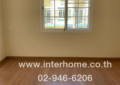 Bedroom with window and wood flooring