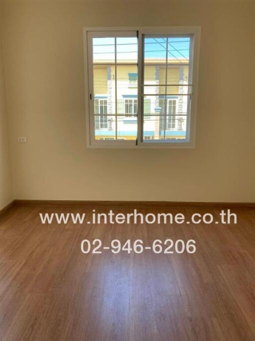 Bedroom with window and wood flooring